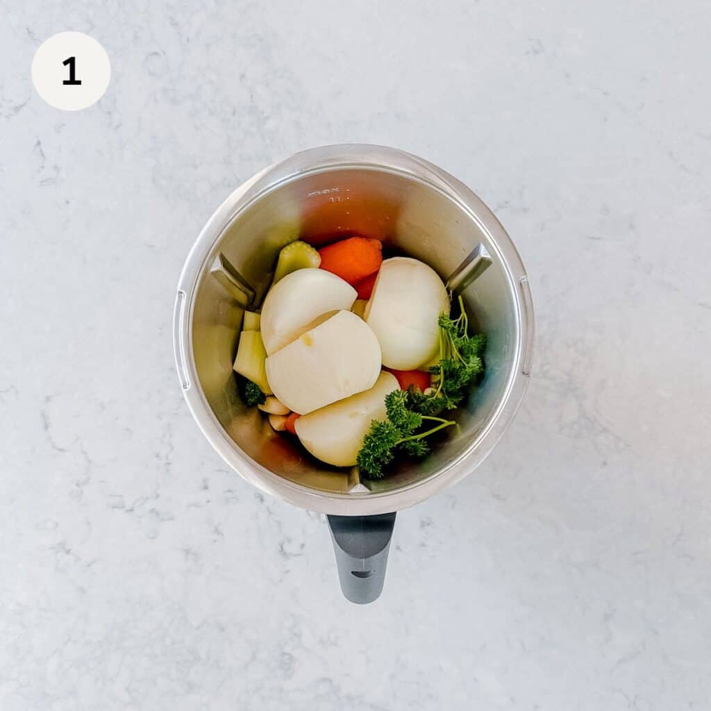 Raw vegetables in a metal jug.