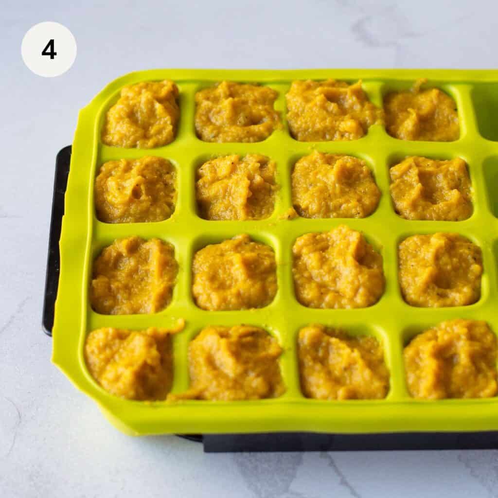 Vegetable stock cubes in a green ice cube container.