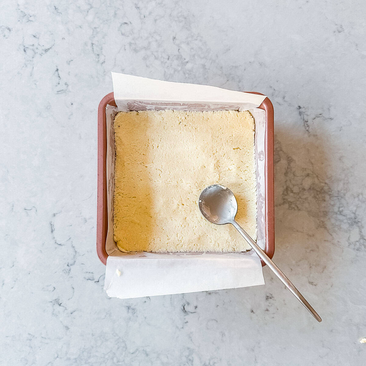Coconut Ice in a square pink baking tray.