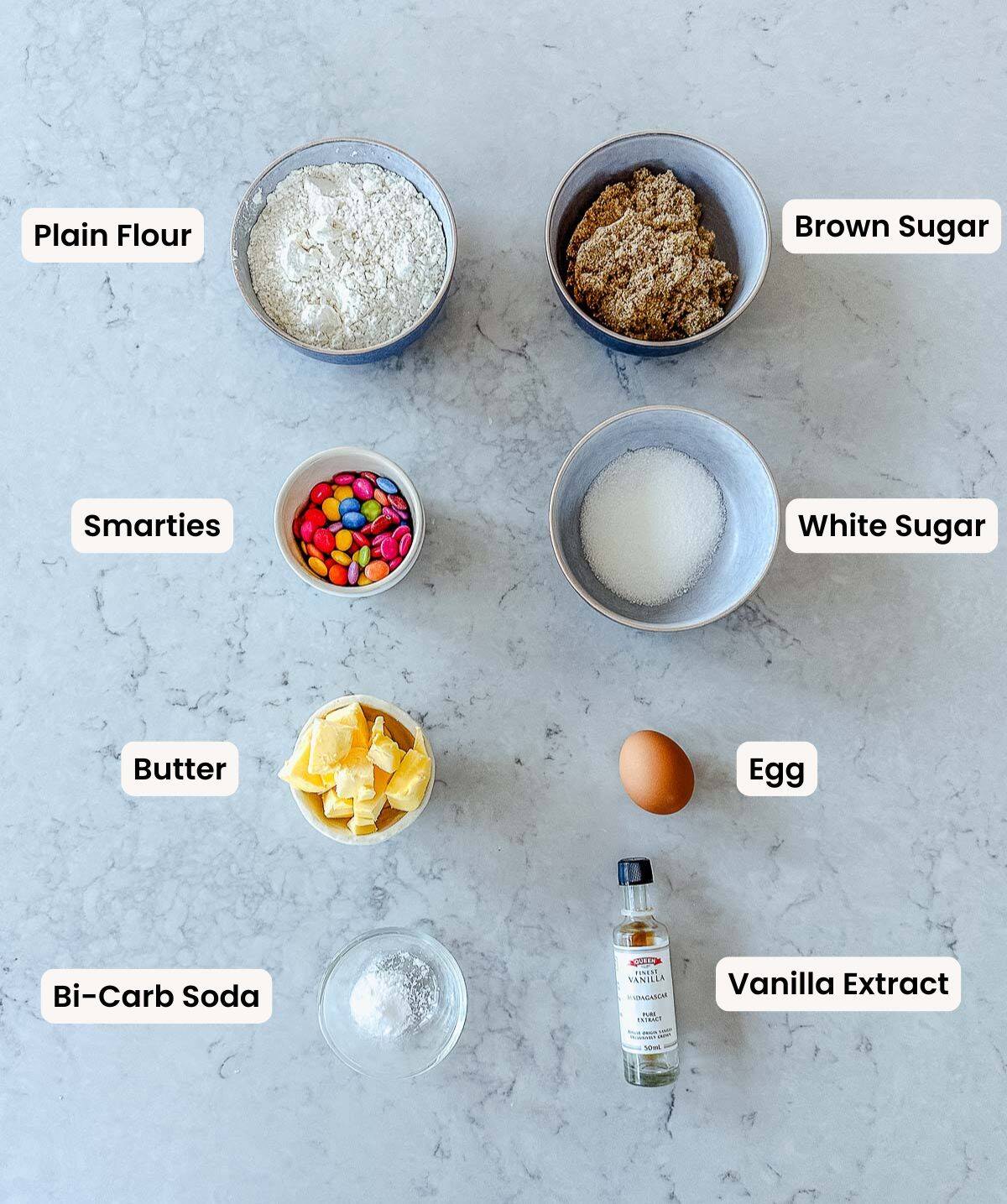 A collection of ingredients needed to make Smartie Cookies.