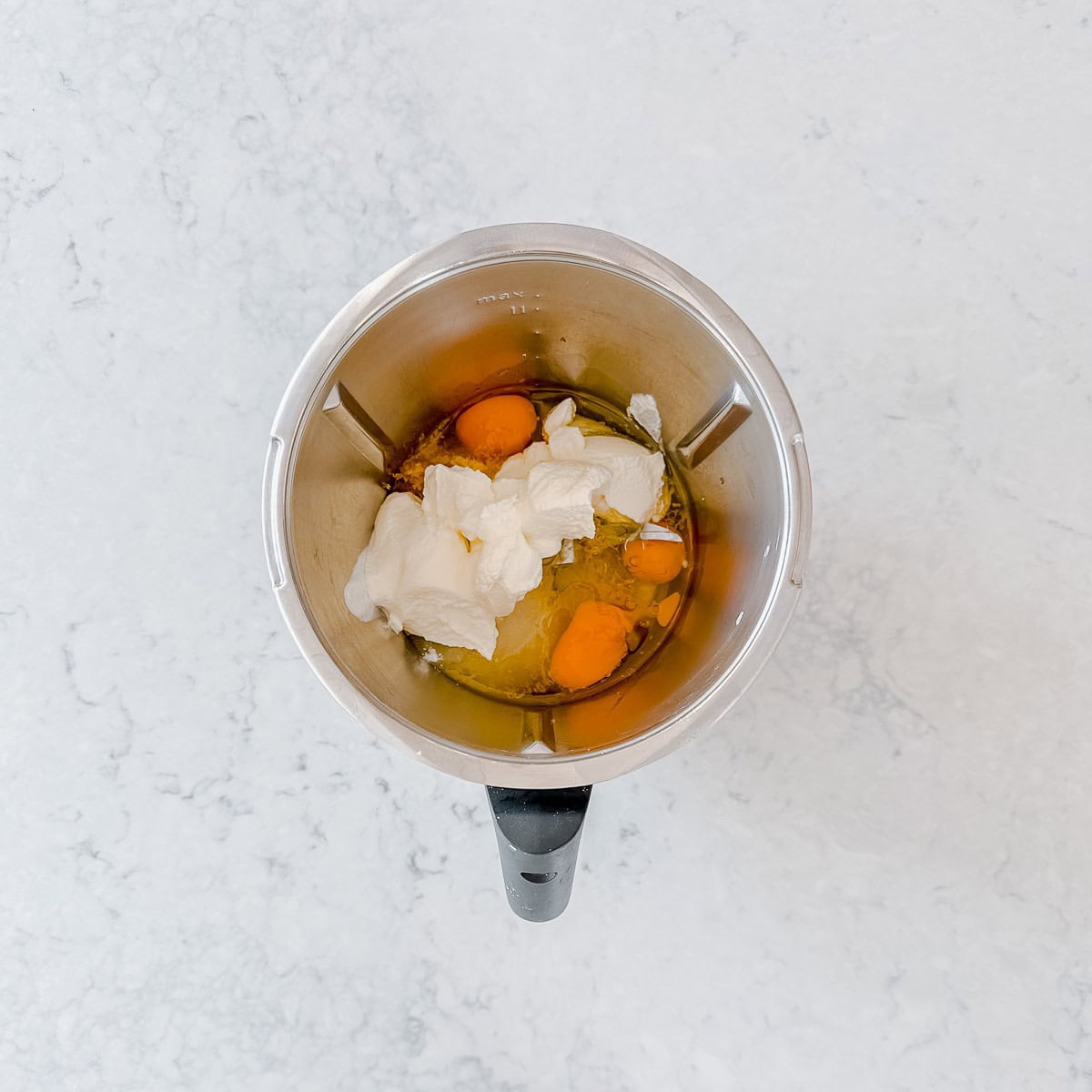 Eggs, sugar, oil and lemon zest in a thermomix bowl.