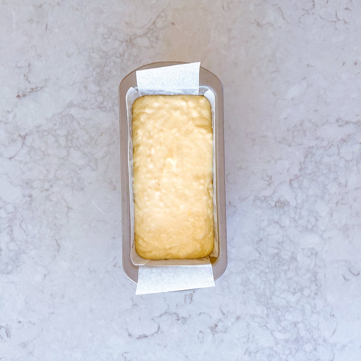 Cake batter in a rectangle shaped baking tin.